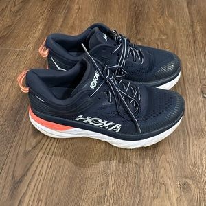 Navy hokas with a bright coral pop on the side!